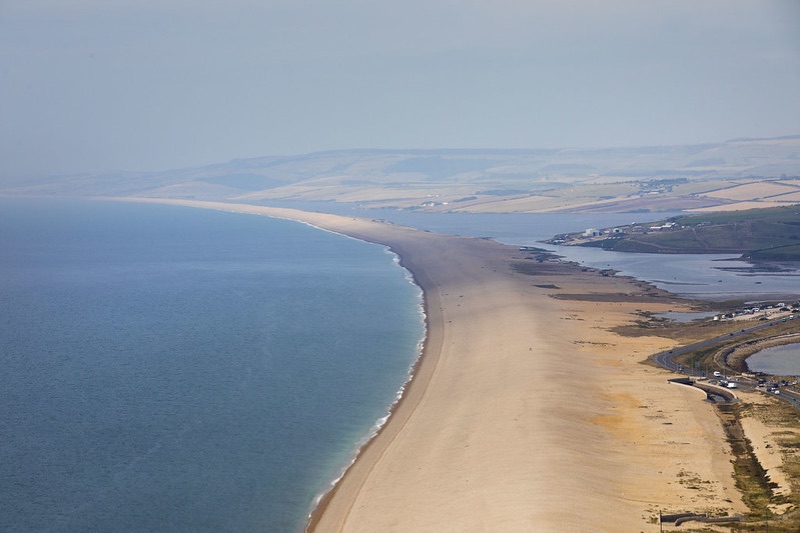 Aerial view of Chesil Beach curving away from Portland towards the mainland